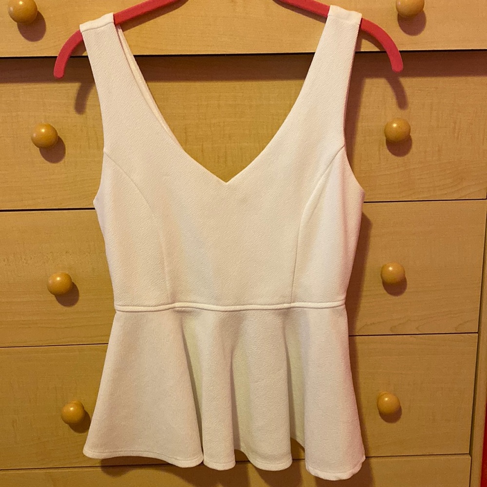 Sleeveless white peplum top